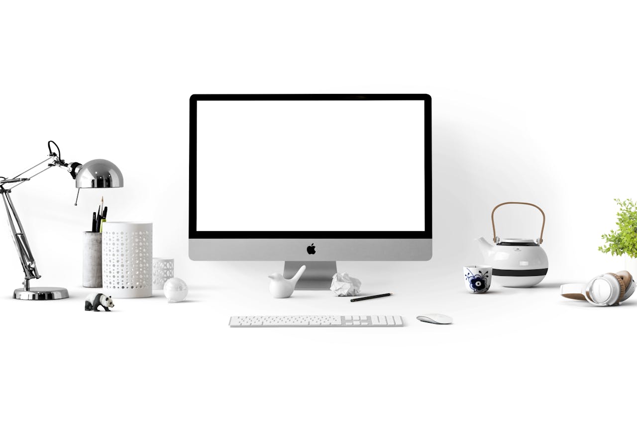 hero-img Minimalist office desk with an iMac, lamp, and stationary, perfect for tech backgrounds.